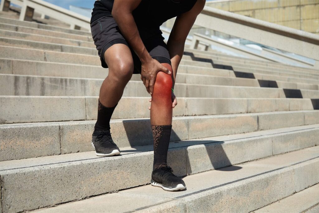 closeup young man with knee injury
