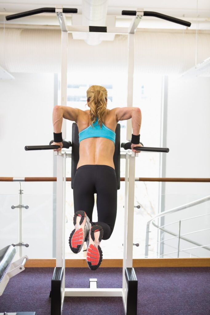 rear view fit woman doing crossfit fitness workout gym